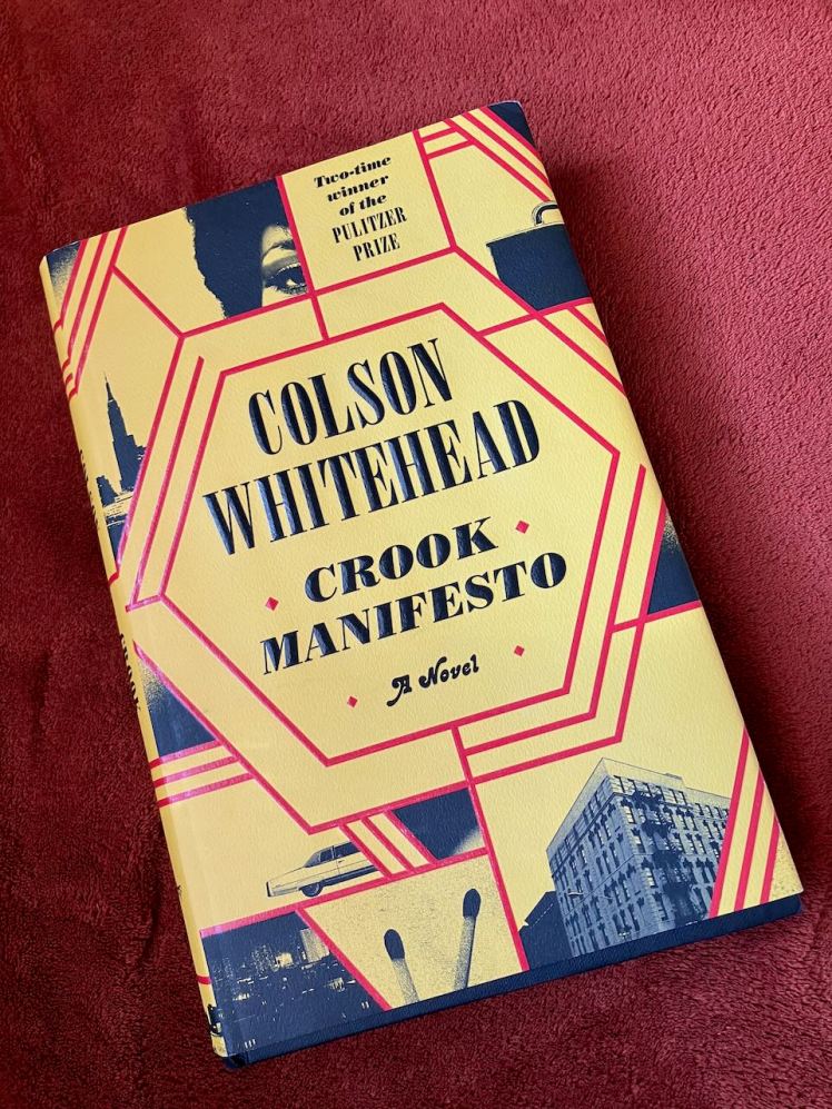 Photo of Crook Manifesto by Colson Whitehead against burnt orange background